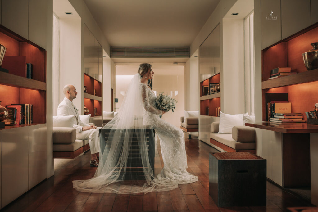 Bride sitting gracefully in her wedding dress, captured with elegance and detail, showcasing luxury wedding photography style.
